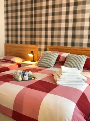 a bedroom with two beds with a tray of dishes on it at The Rutland in Blackpool
