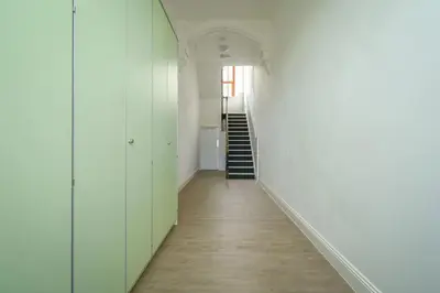 an empty hallway with white walls and a staircase at Suite in the heart of Great Harwood in Great Harwood