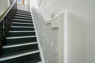 a staircase in a building with a stair case at Suite in the heart of Great Harwood in Great Harwood