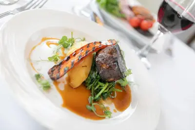 a plate of food with meat and vegetables on a table at Imperial Hotel Blackpool in Blackpool