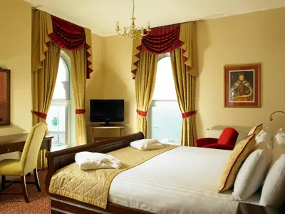 a bedroom with a large bed and a window at Imperial Hotel Blackpool in Blackpool