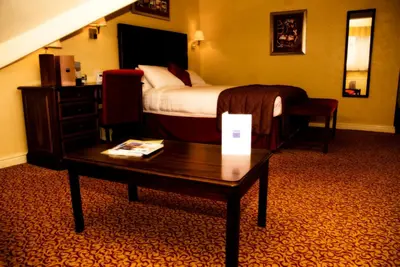 a hotel room with a bed and a coffee table at Imperial Hotel Blackpool in Blackpool