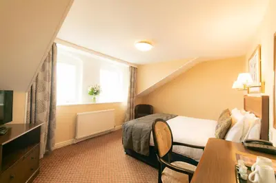 a hotel room with a bed and a window at Imperial Hotel Blackpool in Blackpool