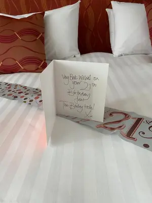 a sign sitting on top of a bed at The Bailey Hotel Blackpool in Blackpool