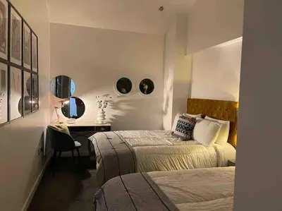a bedroom with two beds and a desk and a mirror at Fantastic Liverpool City Centre Apartments, Fenwick Street in Liverpool
