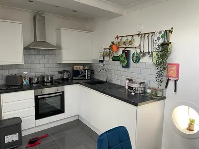 a kitchen with white cabinets and a black counter top at Fantastic Liverpool City Centre Apartments, Fenwick Street in Liverpool