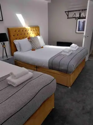 a hotel room with two beds with towels on them at Fantastic Liverpool City Centre Apartments, Fenwick Street in Liverpool