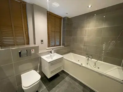 a bathroom with a tub and a toilet and a sink at Fantastic Liverpool City Centre Apartments, Fenwick Street in Liverpool