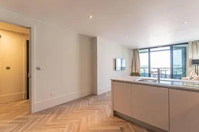 a kitchen with a sink and a large window at 1BR Apt - Balcony - River View in Liverpool