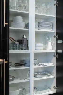 a white cabinet filled with plates and dishes at Meadowcroft in Lindale