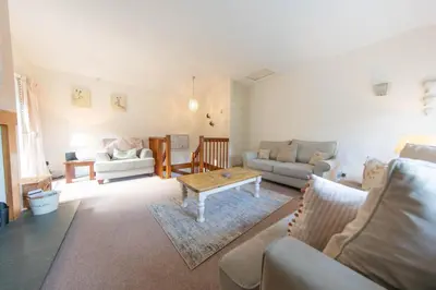 a living room with a couch and a coffee table at Meadowcroft in Lindale