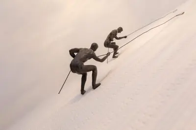 two people skiing up a hill with a rope at Meadowcroft in Lindale