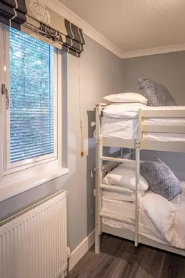 a room with two bunk beds and a window at Lakeland Lodge 9B Arnside , Carnforth ,Lancaster , LA61BH in Carnforth