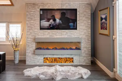 a living room with a fireplace with a tv above it at Lakeland Lodge 9B Arnside , Carnforth ,Lancaster , LA61BH in Carnforth