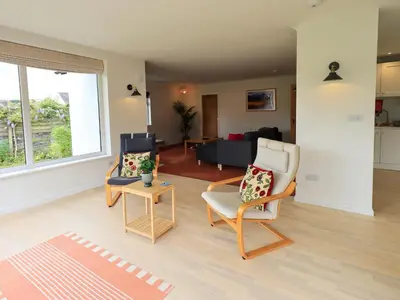 a living room with two chairs and a couch at Pembroke in Grange Over Sands