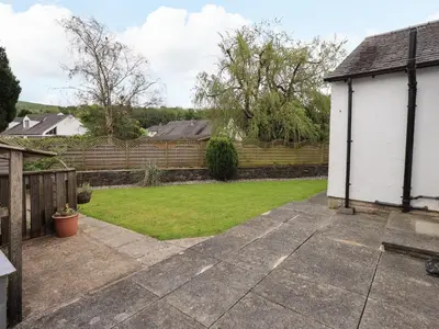 a backyard with a fence and a yard at Pembroke in Grange Over Sands
