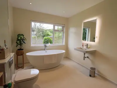 a bathroom with a large tub and a sink at Pembroke in Grange Over Sands