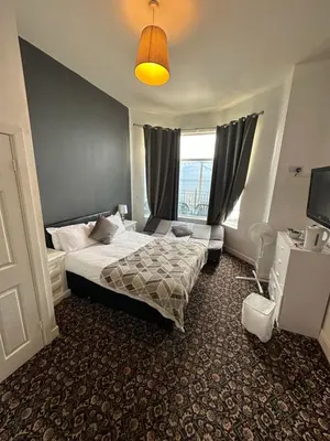 a hotel room with a bed and a window at North Ocean Hotel in Blackpool