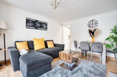 a living room with a couch and a table at LIVERPOOL HOME with FREE PARKING in West Derby
