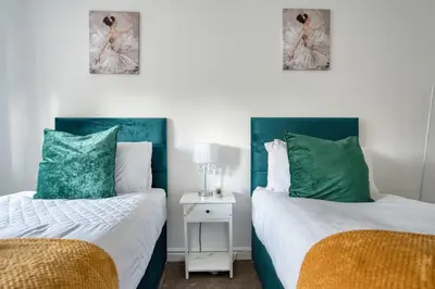 two beds in a room with green and white at LIVERPOOL HOME with FREE PARKING in West Derby