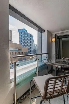 a balcony with a table and chairs and a view of a city at 1 Bed Apt - Balcony - City View - Great Location in Liverpool