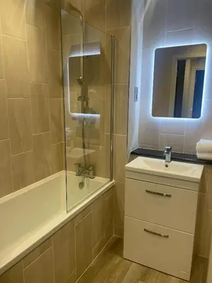 a bathroom with a shower and a sink and a tub at 1 Bed Apt - Balcony - City View - Great Location in Liverpool