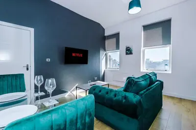 a living room with a couch and a table at Stylish Apartment located in the City Centre of Liverpool - Web-exclusive offers at a-kapartments in Liverpool