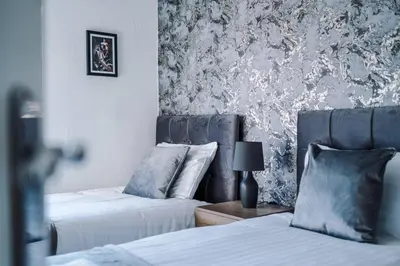 two beds sitting next to each other in a bedroom at Stylish Apartment located in the City Centre of Liverpool - Web-exclusive offers at a-kapartments in Liverpool