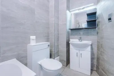 a white bathroom with a toilet and a sink at Stylish Apartment located in the City Centre of Liverpool - Web-exclusive offers at a-kapartments in Liverpool