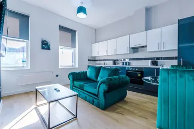 a living room with a couch and a table at Stylish Apartment located in the City Centre of Liverpool - Web-exclusive offers at a-kapartments in Liverpool