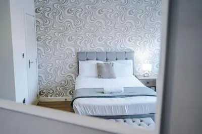 a reflection of a bedroom with a bed in a mirror at Stylish Apartment located in the City Centre of Liverpool - Web-exclusive offers at a-kapartments in Liverpool