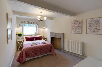 a bedroom with a large bed and a fireplace at Eller How House - Private Regency Property & Lake in Lindale