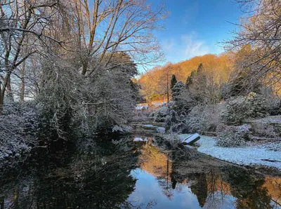 a river with snow on the water and trees at Eller How House - Private Regency Property & Lake in Lindale