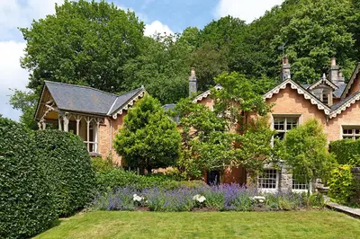 a house with a garden in front of it at Eller How House - Private Regency Property & Lake in Lindale