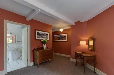 a bathroom with a desk and a sink and a toilet at Eller How House - Private Regency Property & Lake in Lindale