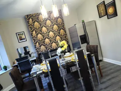 a dining room with a long table and chairs at Clifton House, For Holidays, Contractors, Relocation, Work, Etc, Free Parking and Wifi in Preston