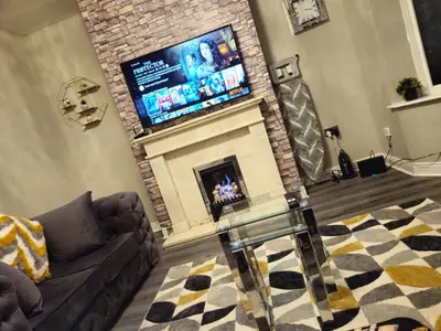 a living room with a fireplace with a flat screen tv at Clifton House, For Holidays, Contractors, Relocation, Work, Etc, Free Parking and Wifi in Preston