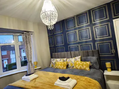 a bedroom with a bed and a chandelier at Clifton House, For Holidays, Contractors, Relocation, Work, Etc, Free Parking and Wifi in Preston