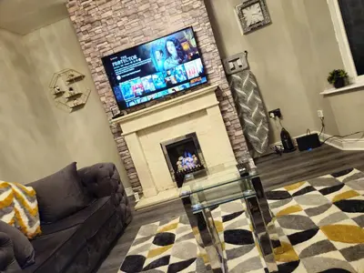 a living room with a fireplace with a flat screen tv at Clifton House, For Holidays, Contractors, Relocation, Work, Etc, Free Parking and Wifi in Preston