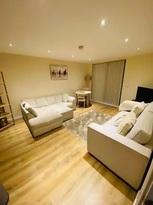 a living room with two white couches and a table at Liverpool City Centre Modern Apartment fits 6 people in Liverpool