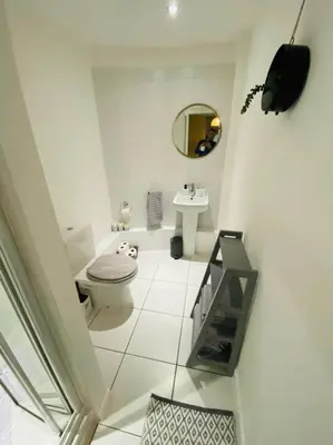 a white bathroom with a toilet and a sink at Liverpool City Centre Modern Apartment fits 6 people in Liverpool