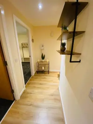 a room with a hallway with a wooden floor at Liverpool City Centre Modern Apartment fits 6 people in Liverpool