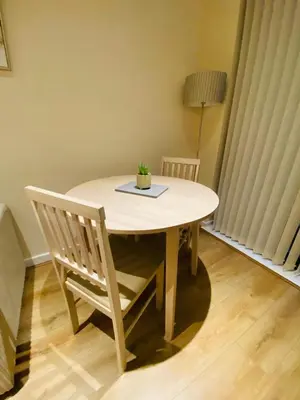 a wooden table with a plant on top of it at Liverpool City Centre Modern Apartment fits 6 people in Liverpool