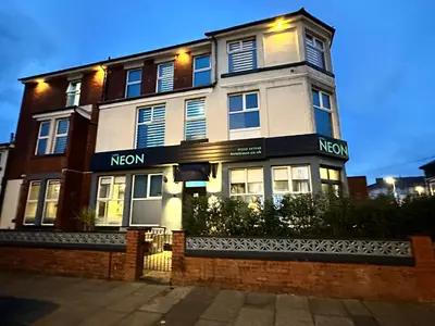 a building with a noren sign on the front of it at Hotel Neon in Blackpool