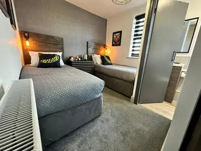 a bedroom with a bed and a couch in it at Hotel Neon in Blackpool