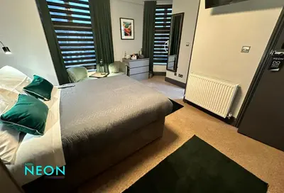 a bedroom with a bed and a television in it at Hotel Neon in Blackpool