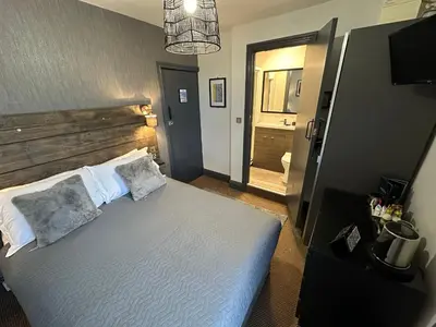 a bedroom with a bed with two pillows at Hotel Neon in Blackpool