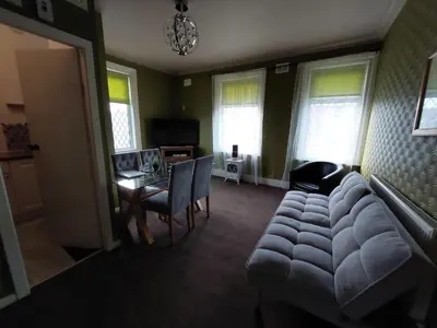 a living room with a couch and a table at Captivating 1-Bed Apartment in Blackpool in Blackpool