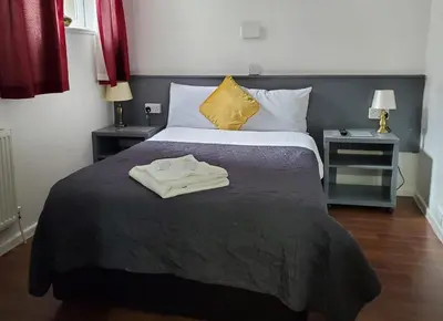 a hotel room with a bed with a robe on it at Brooklyn Hotel in Blackpool