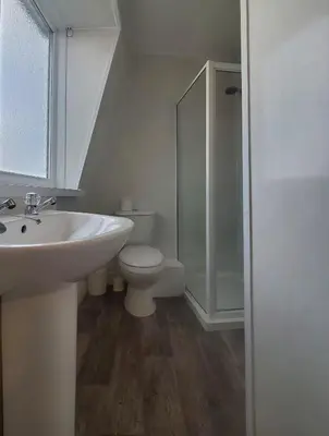 a white bathroom with a sink and a toilet at Brooklyn Hotel in Blackpool